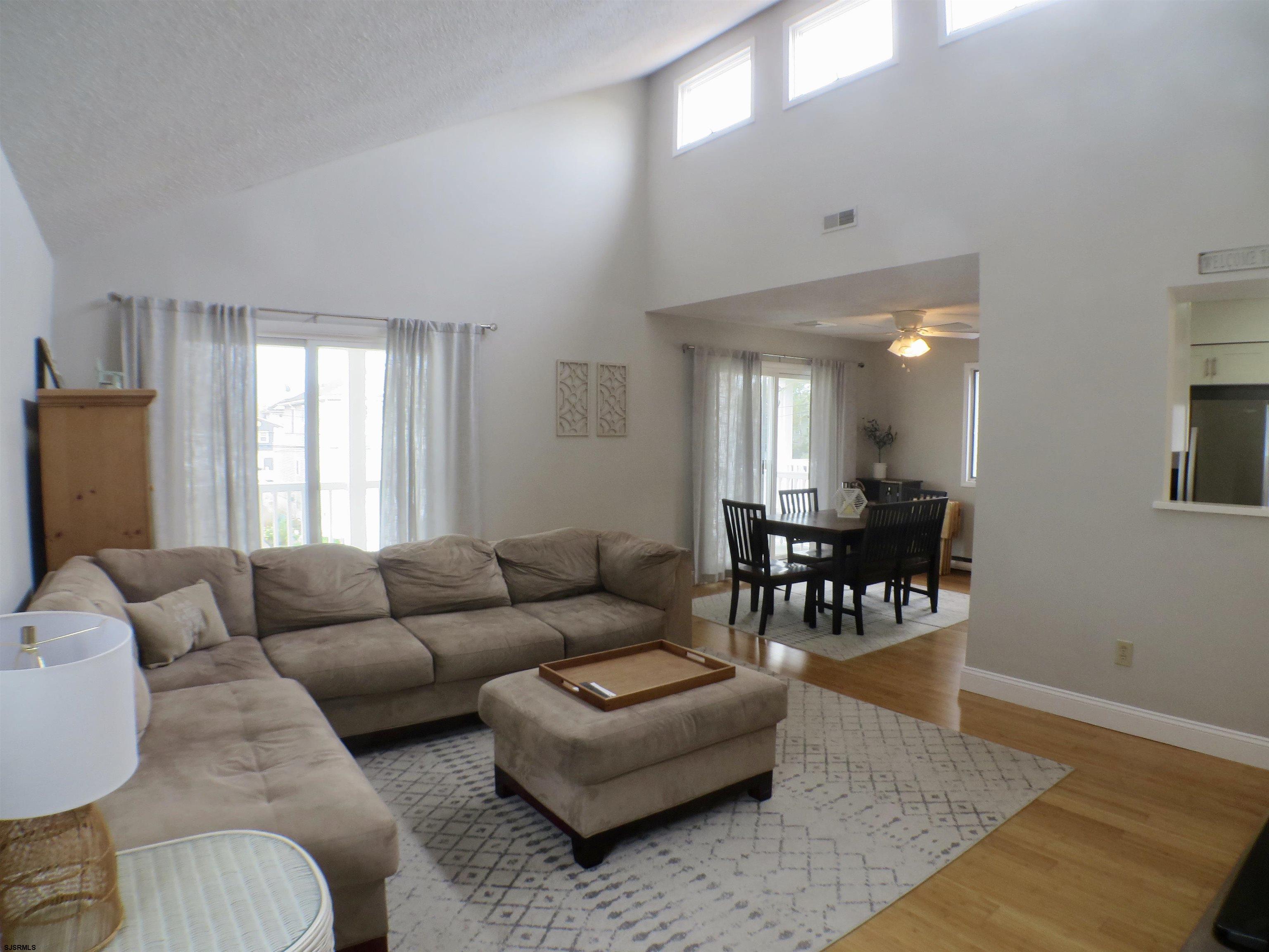 210 Simpson Avenue, Unit 2 Ocean City, NJ 08226 - Photo 2 of 20 a living room with furniture and a large window