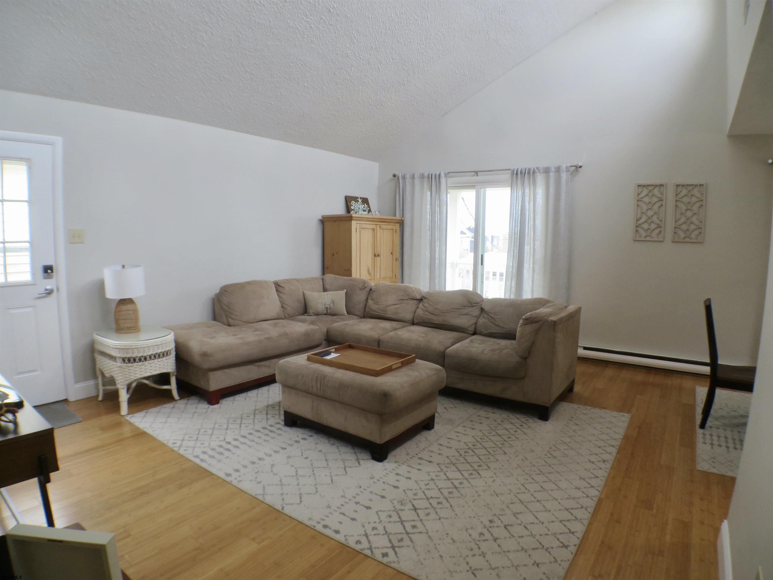 210 Simpson Avenue, Unit 2 Ocean City, NJ 08226 - Photo 3 of 20 a living room with furniture and a couch