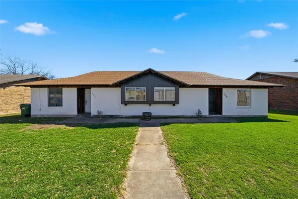 a front view of a house with yard
