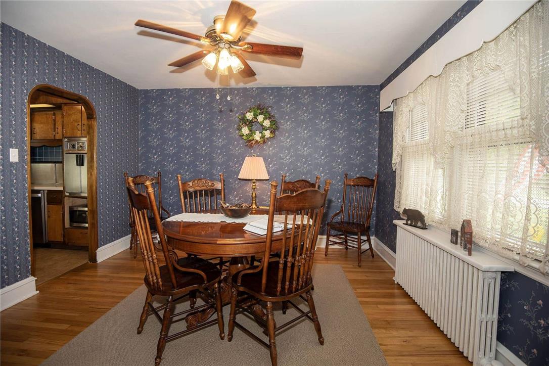 706 Stones Crossing Road Easton, PA 18045 - Photo 15 of 40 Gleaming hardwood floors and a ceiling fan adorn this dining space, ready for your next gathering. View into the cozy kitchen area.