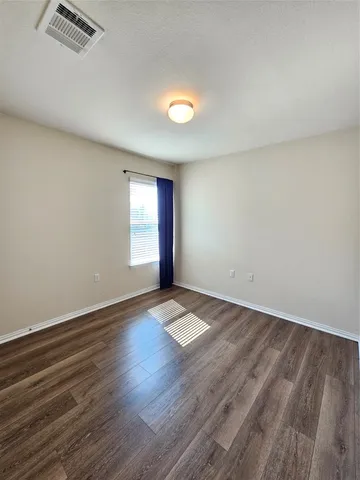 a spacious bathroom with a double vanity sink and mirror