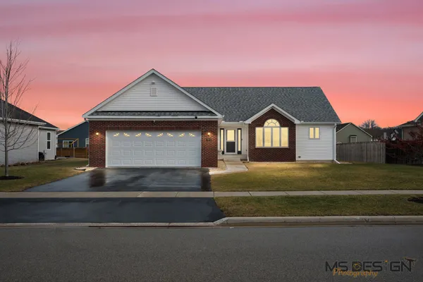 a front view of a house with a yard and garage