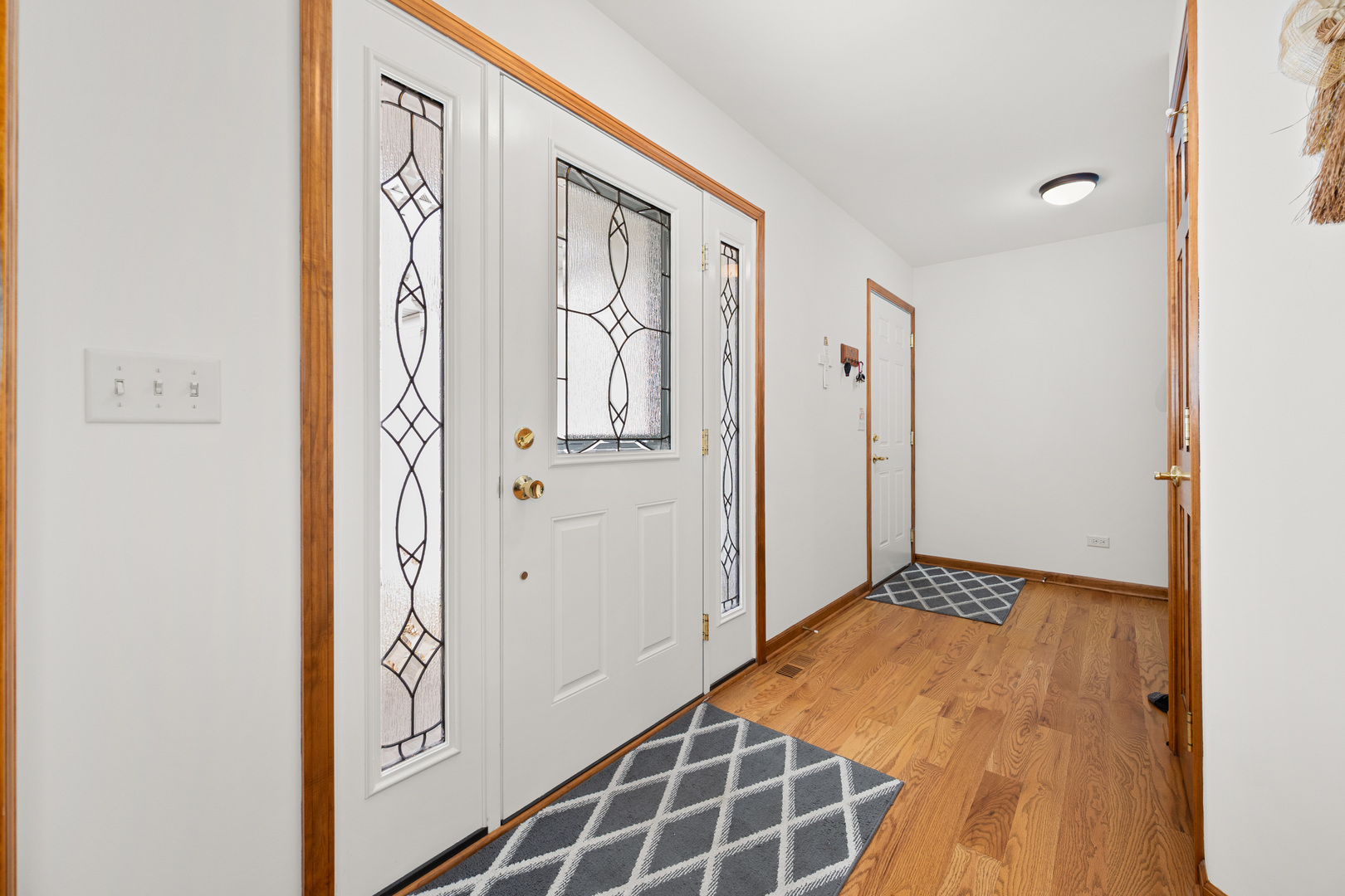 1012 Joshua Lane Genoa, IL 60135 - Photo 13 of 36 a view of a hallway with wooden floor and entryway
