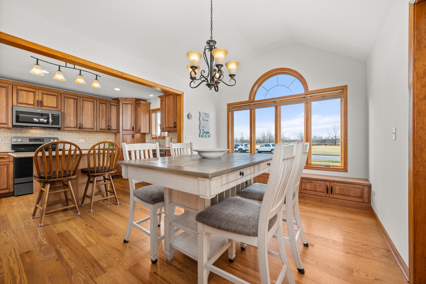 1012 Joshua Lane Genoa, IL 60135 - Photo 15 of 36 a dining room with furniture a chandelier and wooden floor