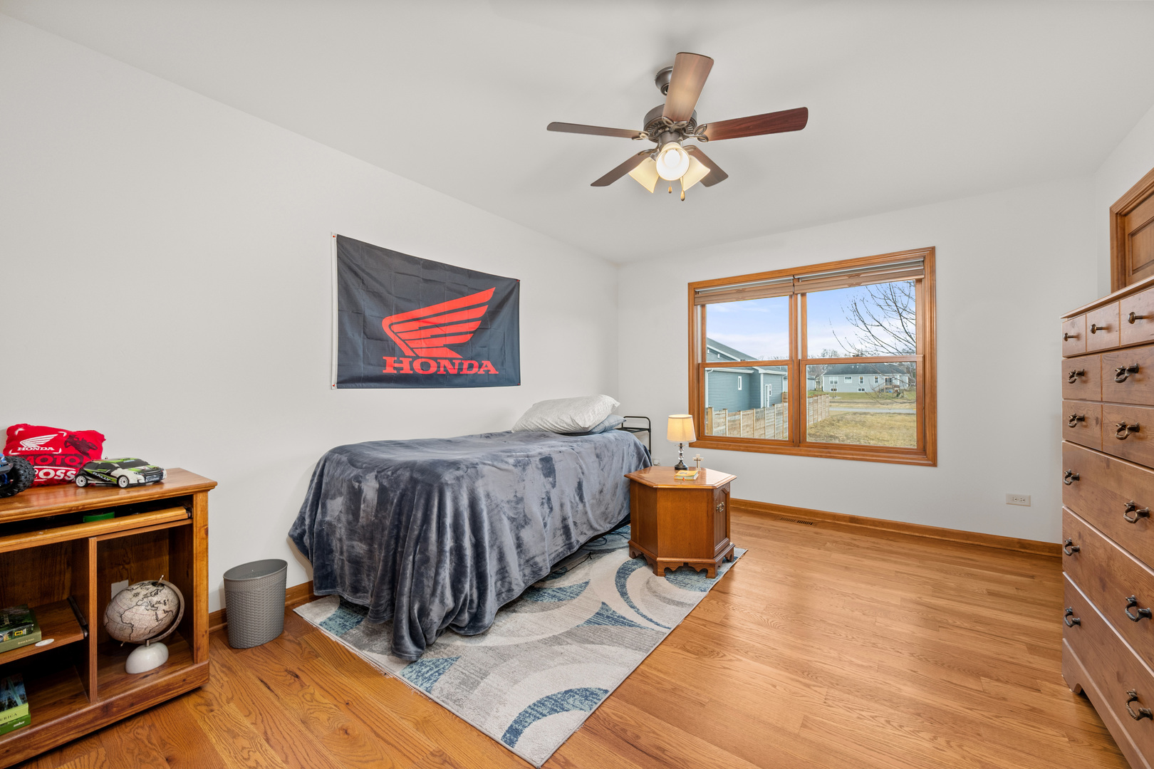 1012 Joshua Lane Genoa, IL 60135 - Photo 30 of 36 a spacious bedroom with a bed and wooden floor