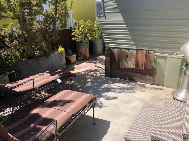 a backyard of a house with outdoor seating