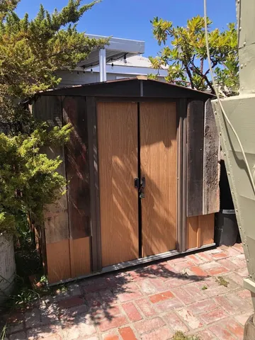a side view of a house with a wooden door