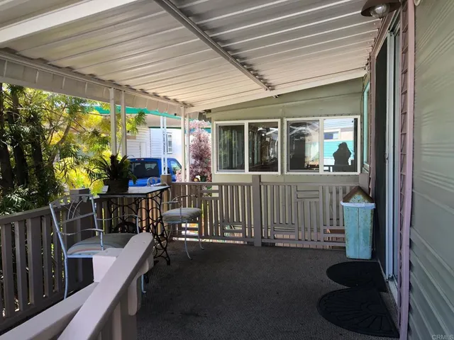 a view of a porch with chairs and backyard
