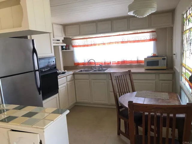 a kitchen with a sink a stove a refrigerator and a stove