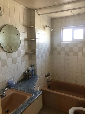 a bathroom with a sink a toilet and bathtub