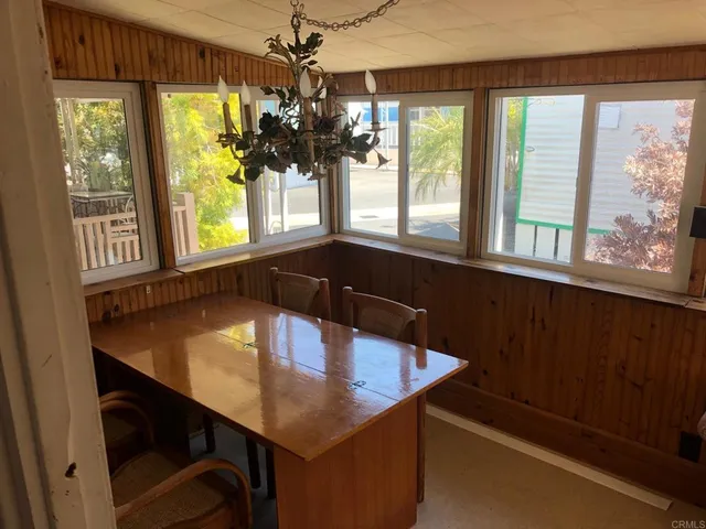 a kitchen with a table chairs and a large window