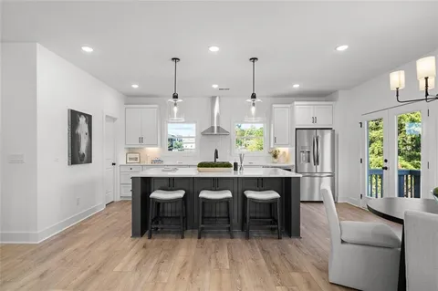 a large kitchen with a table and chairs