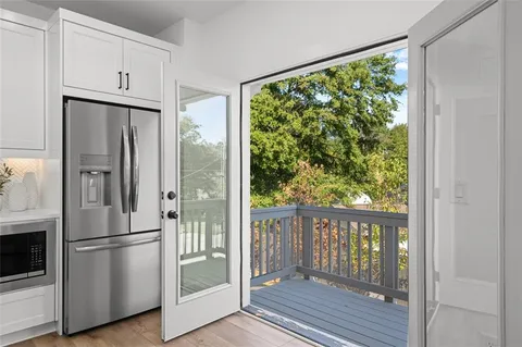 a metallic refrigerator freezer sitting in a kitchen