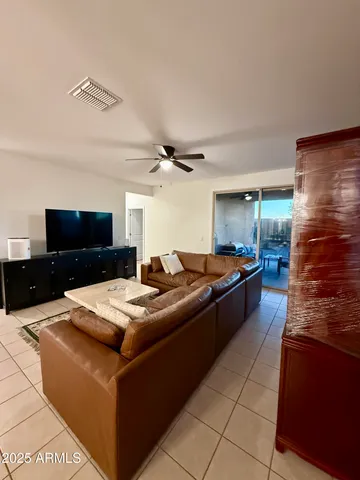 a large kitchen with kitchen island a stove a sink dishwasher and a dining table with the kitchen view