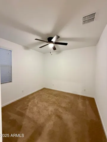 a view of a room with a ceiling fan