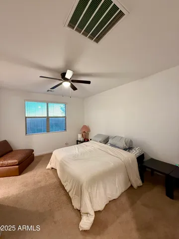 a bedroom with bed and a chandelier