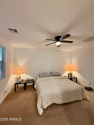 a bedroom with a bed and window