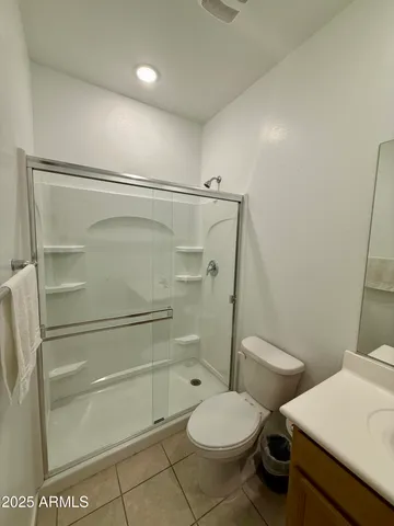 a bathroom with a toilet and a shower