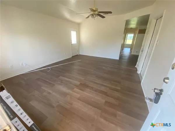 wooden floor in an empty room with a mirror