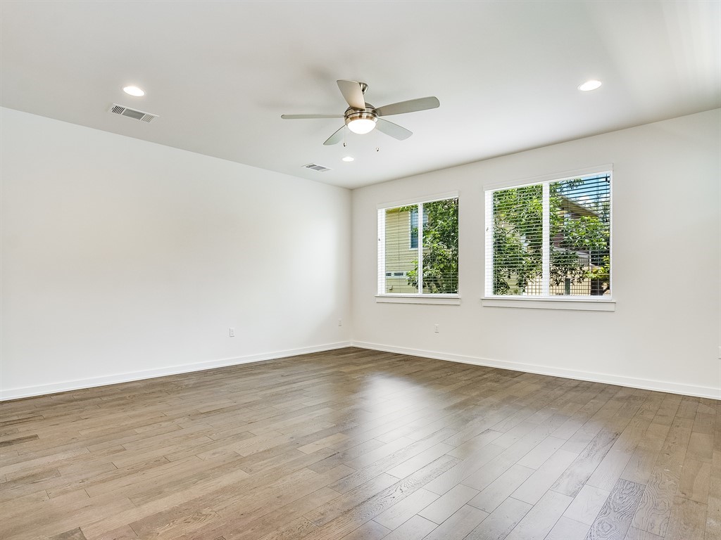 6800 Menchaca Road, Unit 39 Austin, TX 78745 - Photo 8 of 16 Rich wood floors and recessed lighting enhance the architectural simplicity of this spacious room.