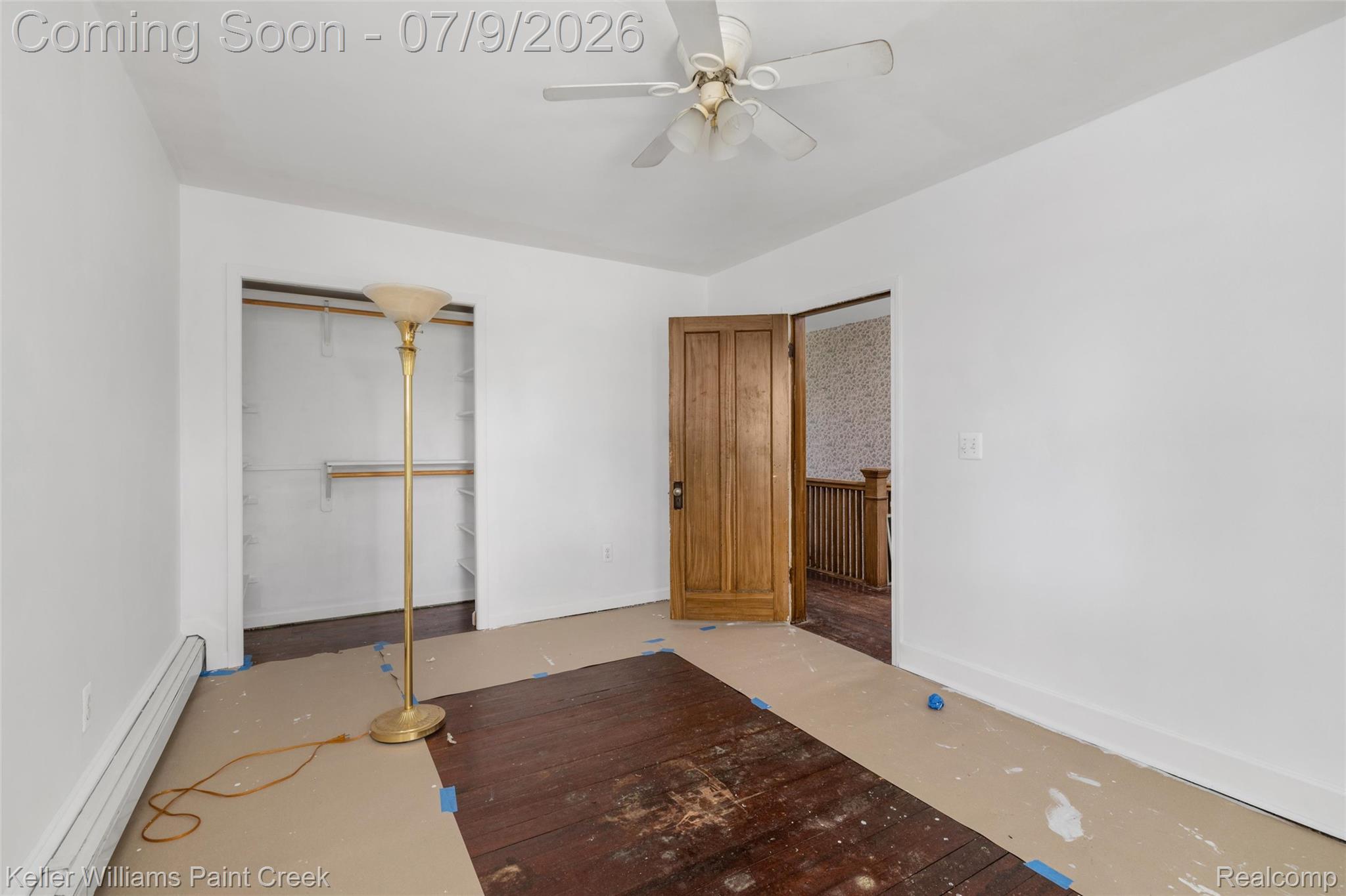 28780 School Section Road Richmond, MI 48062 - Photo 7 of 50 Room featuring a wood-panel door, white painted walls, and wood-finish flooring