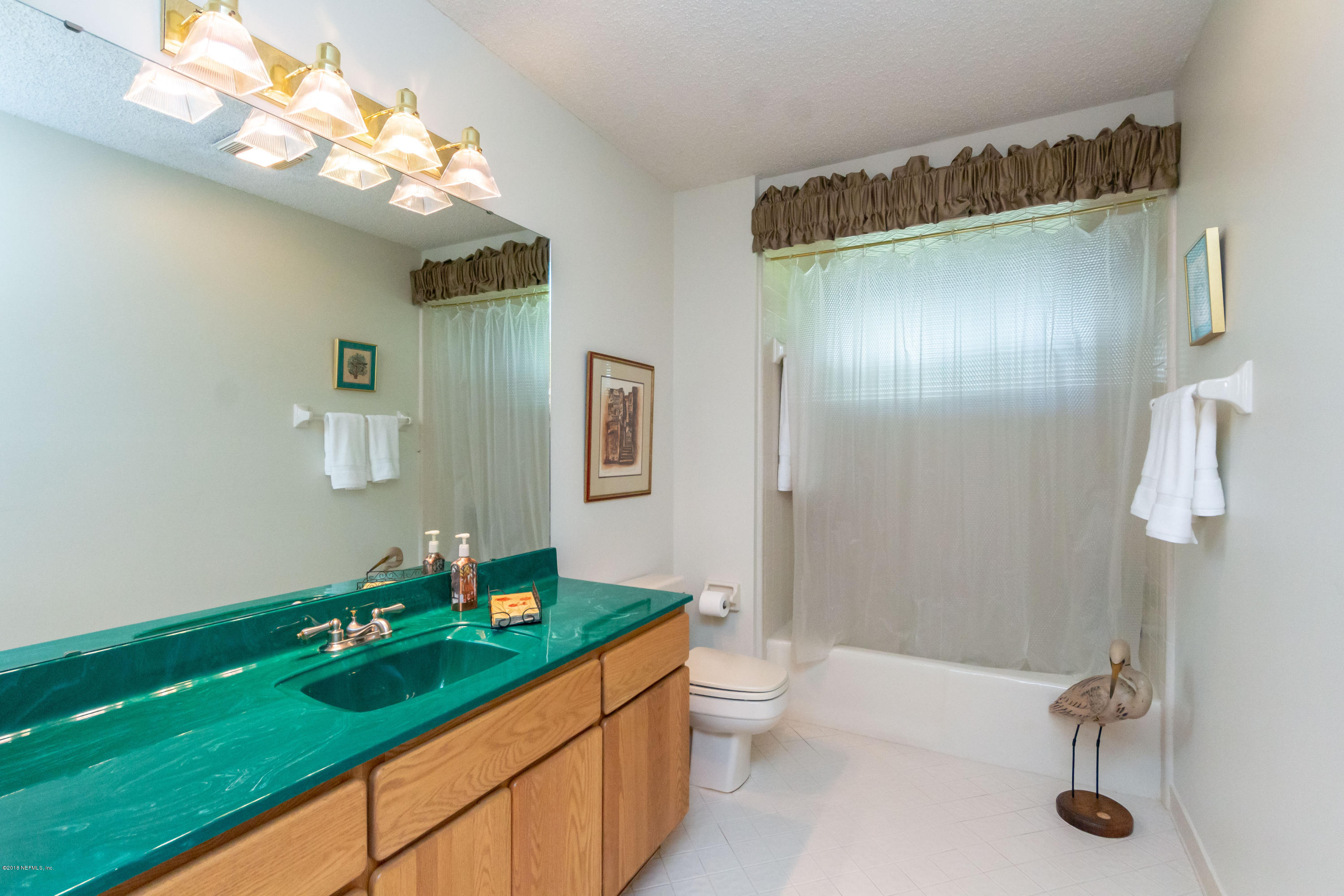2610 Holly Point Road West Orange Park, FL 32073 - Photo 54 of 56 a bathroom with a double vanity sink and a mirror