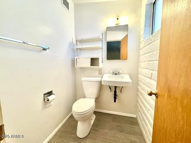 a bathroom with a sink a toilet and shower curtain