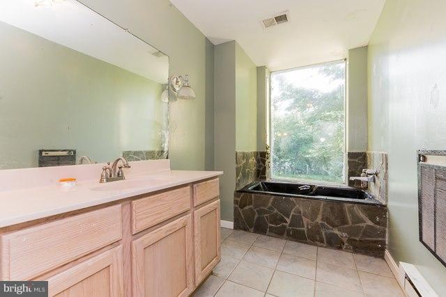 5865 Solomons Island Road Tracys Landing, MD 20779 - Photo 12 of 29 a room with a sink and a mirror