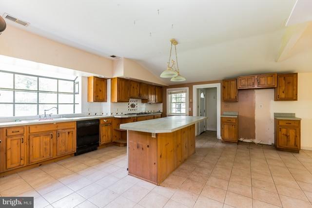 5865 Solomons Island Road Tracys Landing, MD 20779 - Photo 5 of 29 a kitchen with stainless steel appliances kitchen island granite countertop a stove a sink and a refrigerator