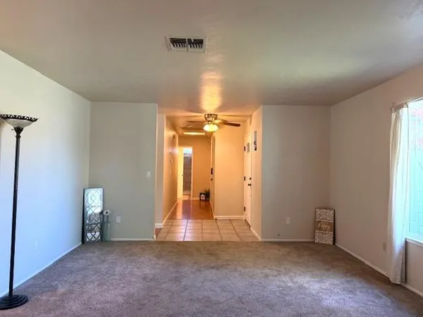 an empty room with closet and a window
