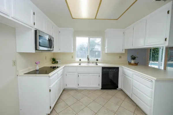 a kitchen with cabinets and window