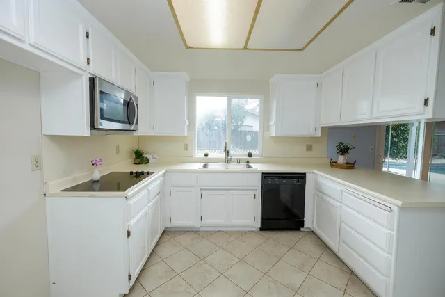 a kitchen with cabinets and window