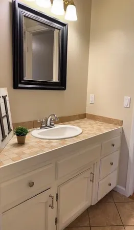 a bathroom with a sink vanity and mirror