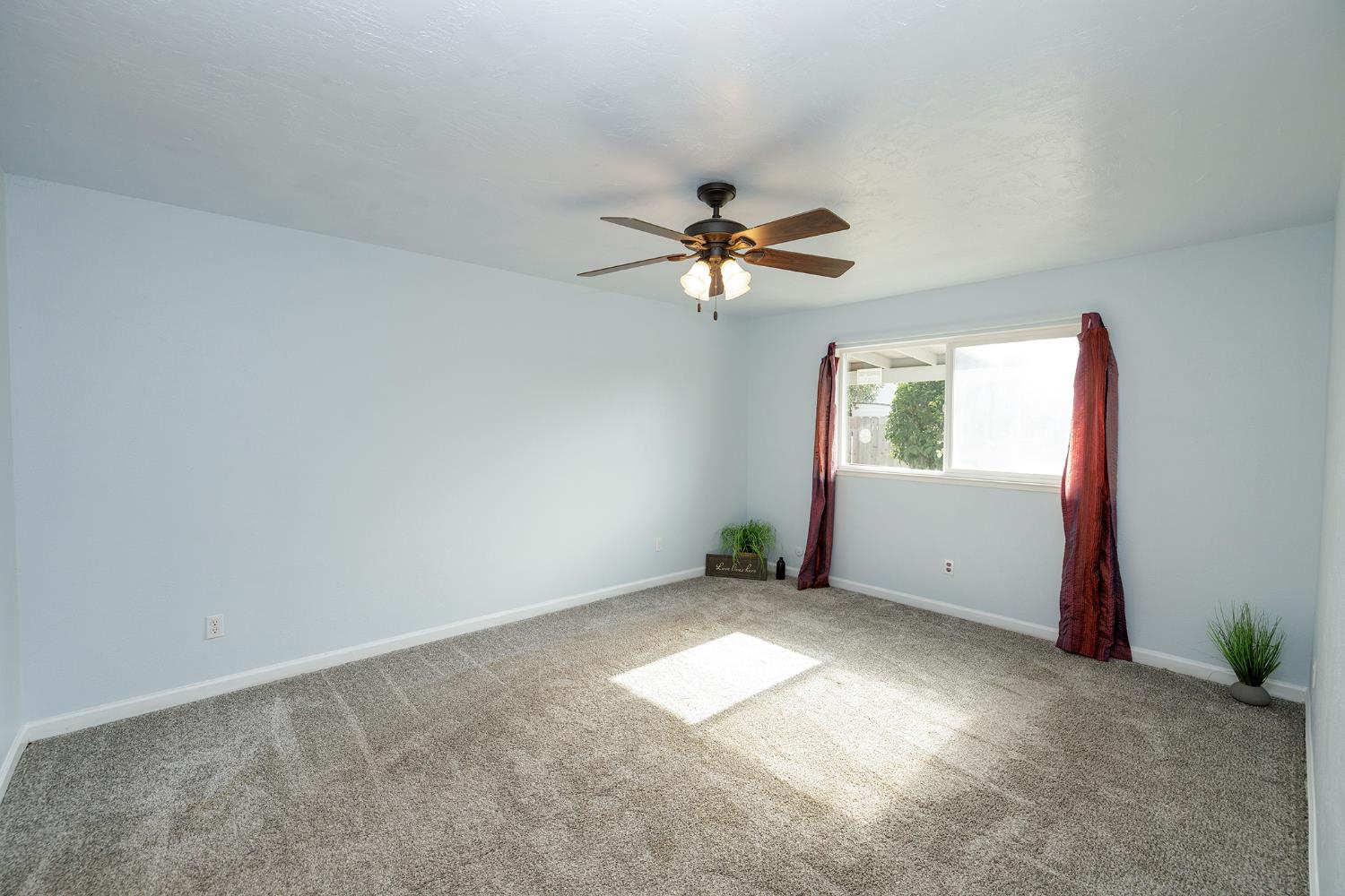 495 Valdapena Way Escalon, CA 95320 - Photo 22 of 43 an empty room with windows and fan