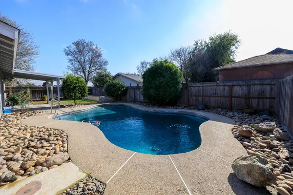 a view of a backyard with sitting area