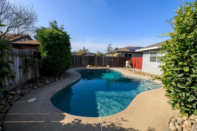 a view of a swimming pool with a patio
