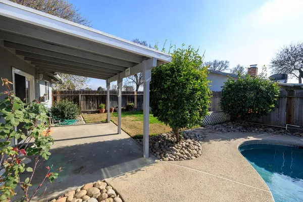 a view of a backyard with sitting area