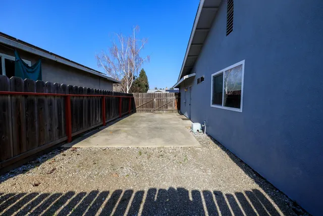 a view of backyard with wooden fence and staircase