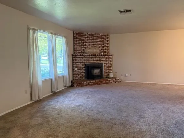 an empty room with a fireplace