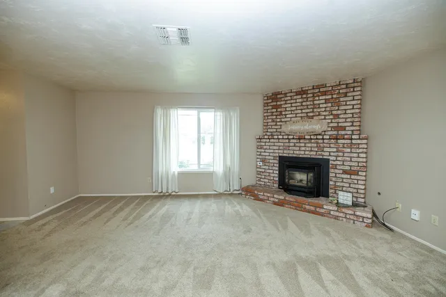 an empty room with a fireplace