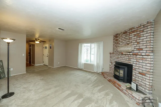 a view of empty room with a fireplace