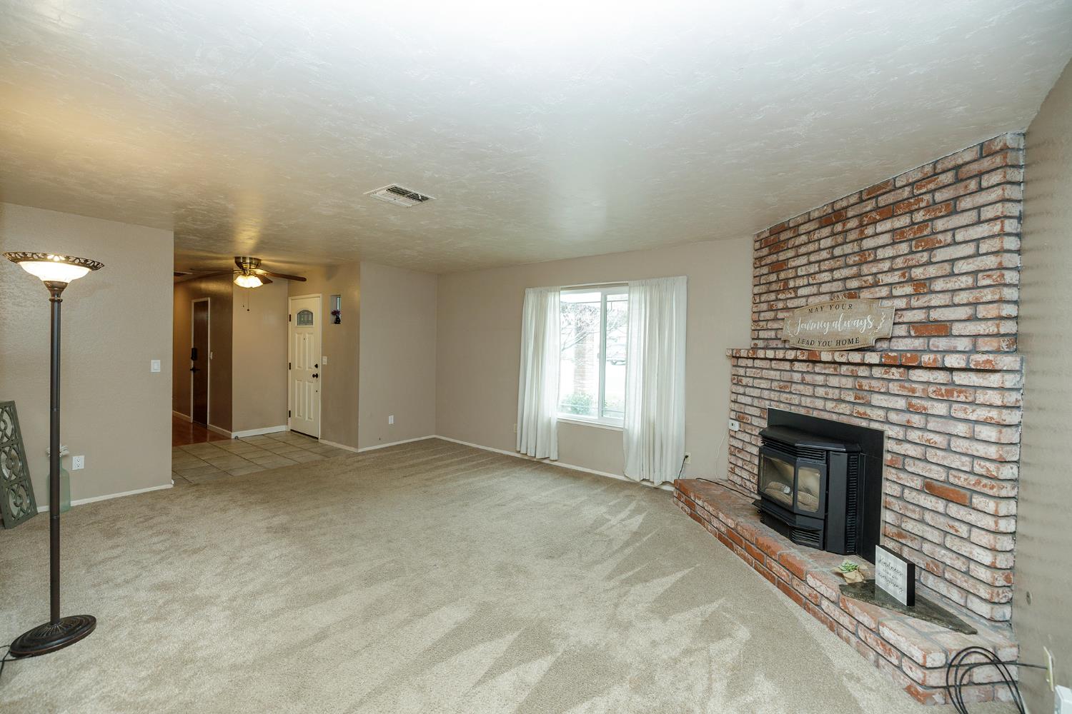 495 Valdapena Way Escalon, CA 95320 - Photo 8 of 43 a view of empty room with a fireplace