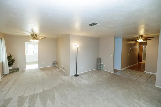 an empty room with entrance and windows