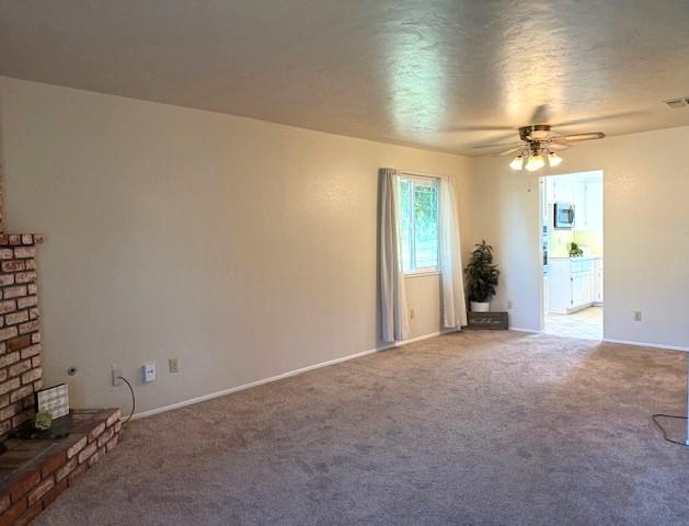 495 Valdapena Way Escalon, CA 95320 - Photo 9 of 38 en empty room with windows and fan