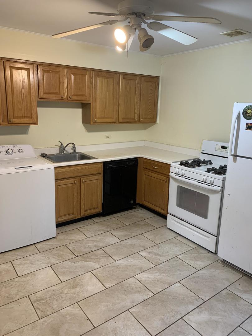 2107 Flicker Lane Rolling Meadows, IL 60008 - Photo 3 of 13 a kitchen with stainless steel appliances granite countertop a stove sink and cabinets