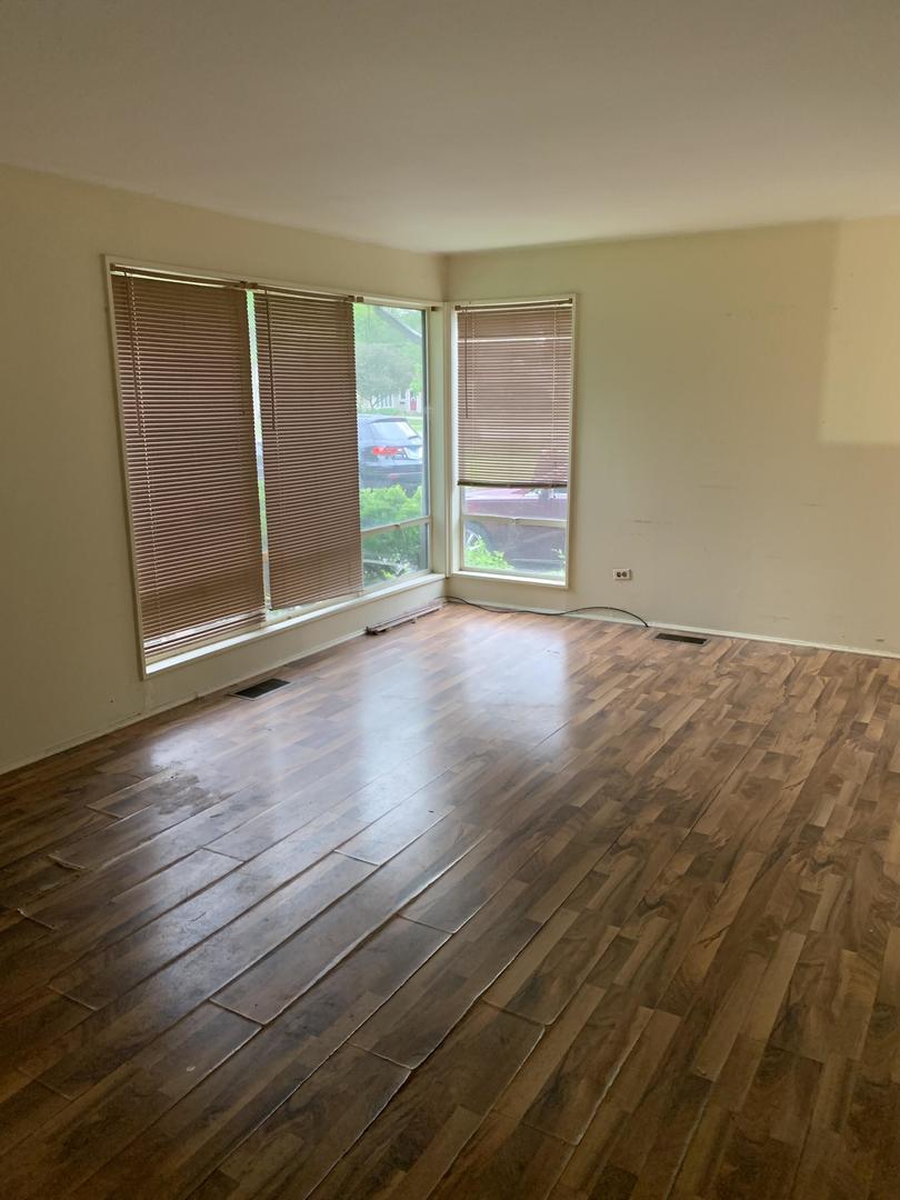 2107 Flicker Lane Rolling Meadows, IL 60008 - Photo 4 of 13 a view of an empty room with wooden floor and a window