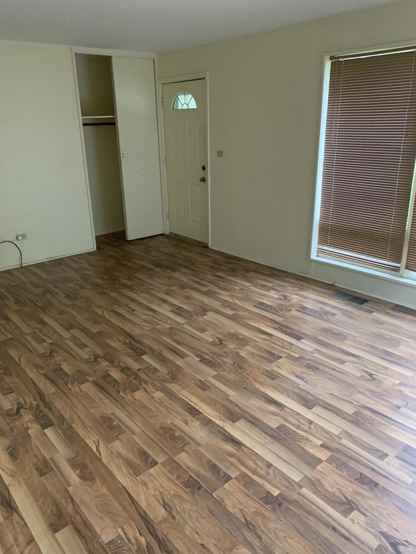 2107 Flicker Lane Rolling Meadows, IL 60008 - Photo 5 of 13 a view of a room with wooden floor and cabinet