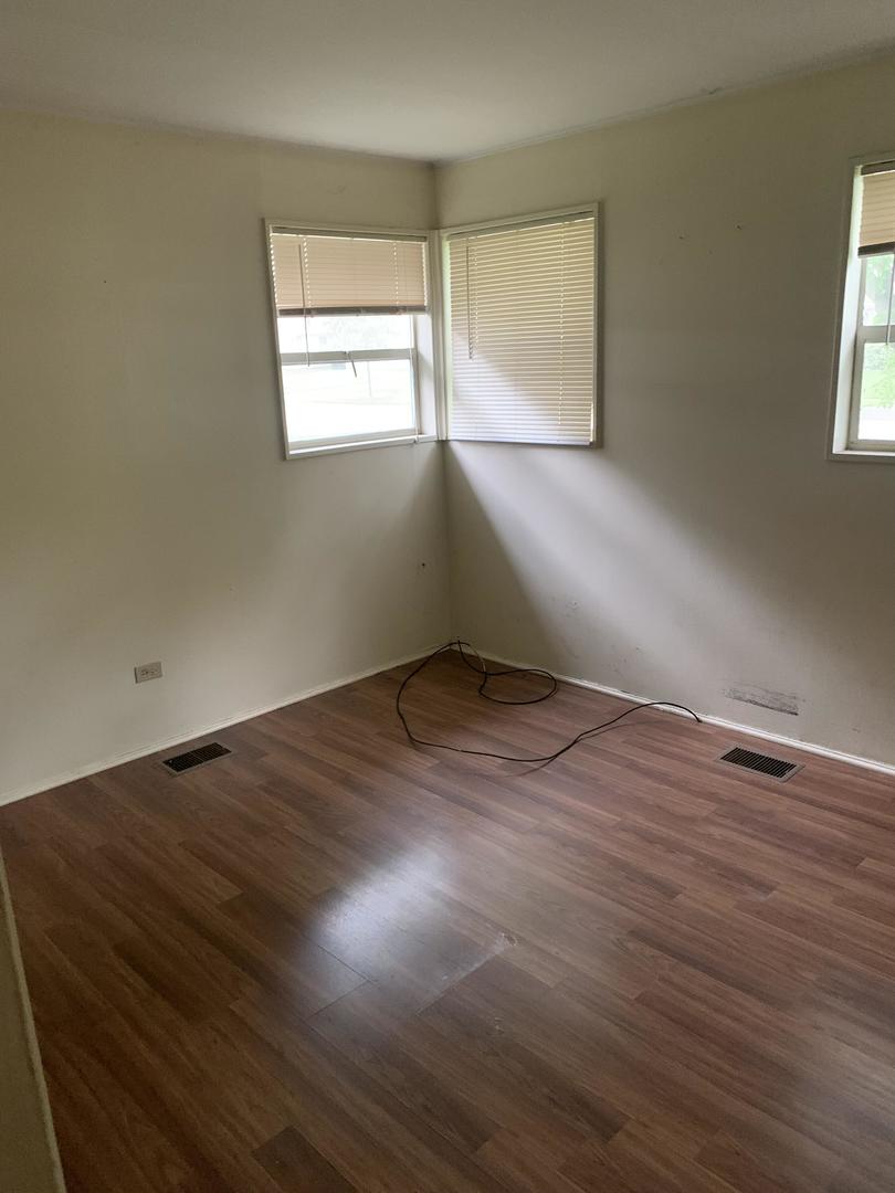 2107 Flicker Lane Rolling Meadows, IL 60008 - Photo 7 of 13 an empty room with wooden floor and windows