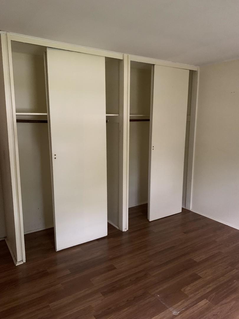 2107 Flicker Lane Rolling Meadows, IL 60008 - Photo 8 of 13 a view of an empty room with wooden floor and a refrigerator