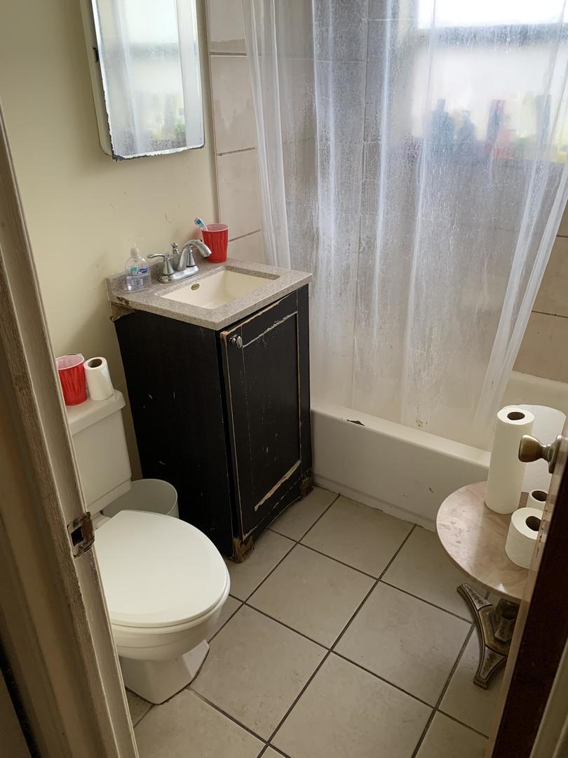 2107 Flicker Lane Rolling Meadows, IL 60008 - Photo 9 of 13 a bathroom with a sink toilet and a mirror